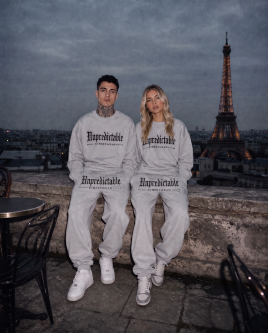 Models wearing Unpredictable Streetwear grey embroidered crew necks on a Paris rooftop